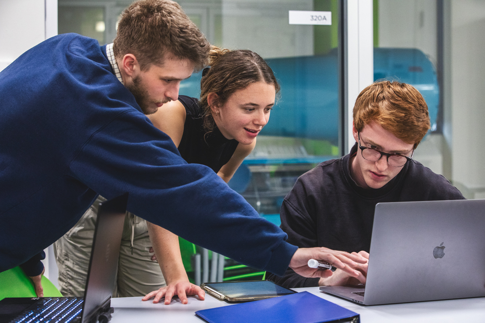 person pointing at laptop screen