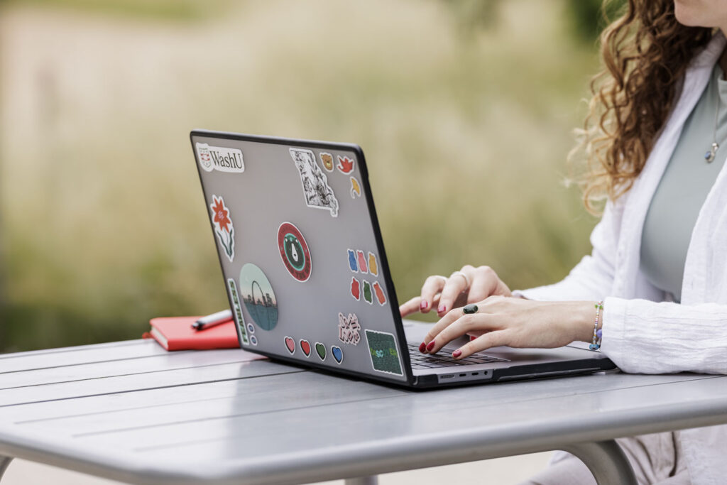 person typing on laptop
